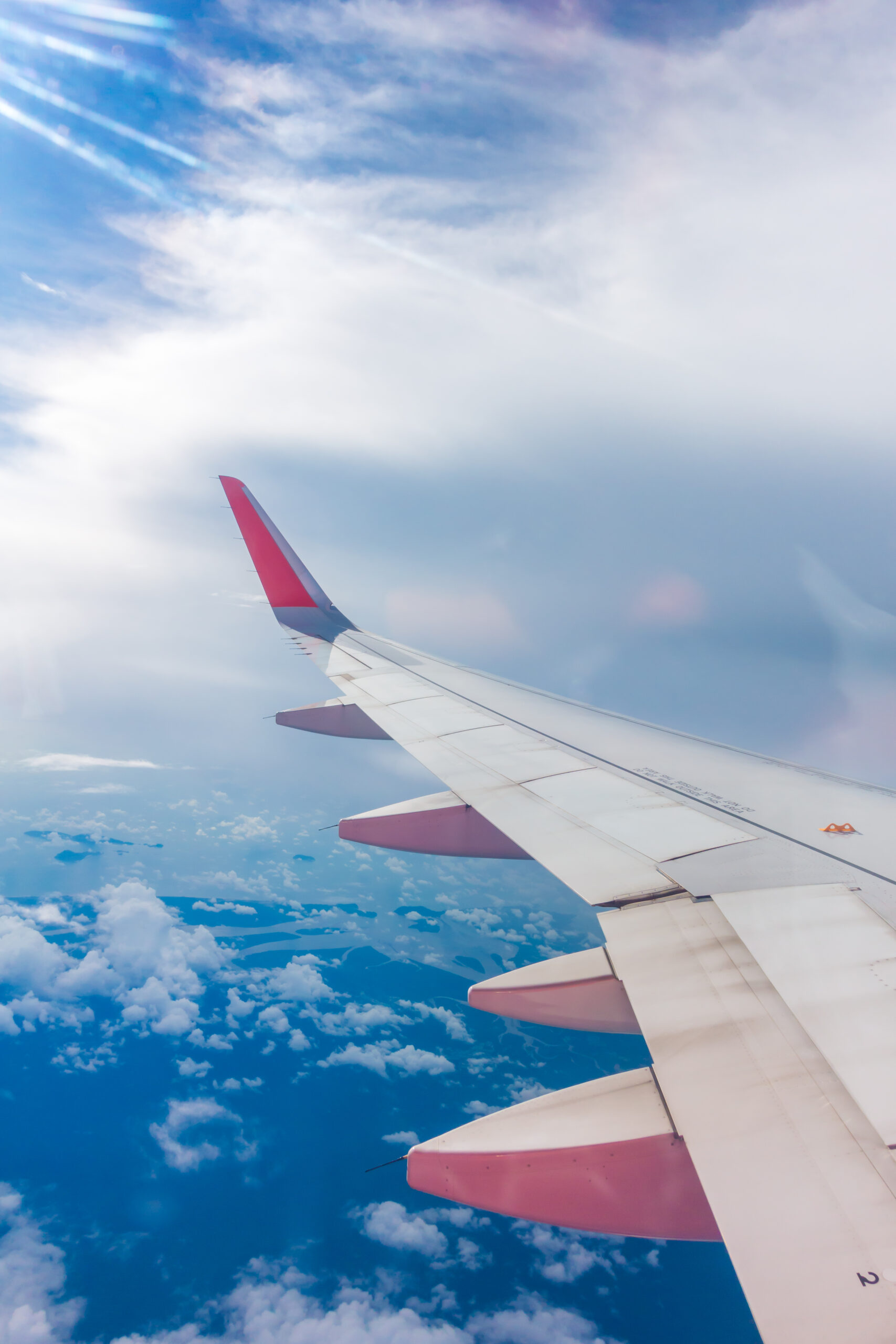 Wing of an airplane flying above the clouds